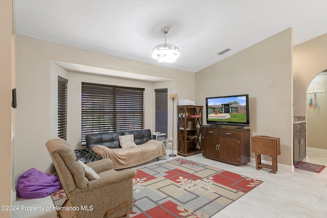 living room featuring light tile patterned floors and lofted ceiling