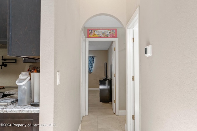 hall featuring light tile patterned flooring