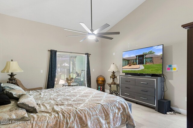 bedroom with ceiling fan and high vaulted ceiling