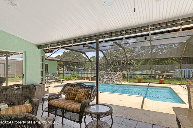 view of swimming pool with a lanai, a patio, and pool water feature