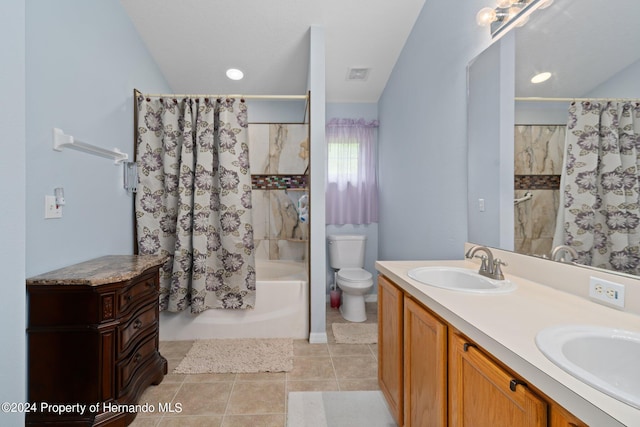 full bathroom with shower / tub combo with curtain, vanity, tile patterned floors, and toilet