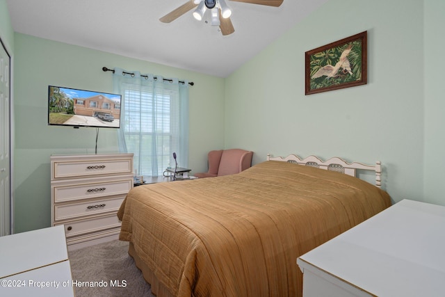 bedroom with light colored carpet, ceiling fan, and vaulted ceiling