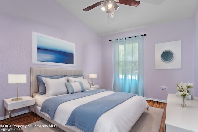 bedroom with vaulted ceiling, hardwood / wood-style flooring, and ceiling fan