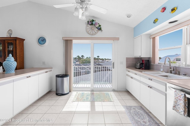 kitchen featuring dishwasher, white cabinetry, and sink