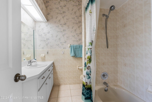 bathroom with tile walls, vanity, tile patterned floors, and shower / tub combo with curtain