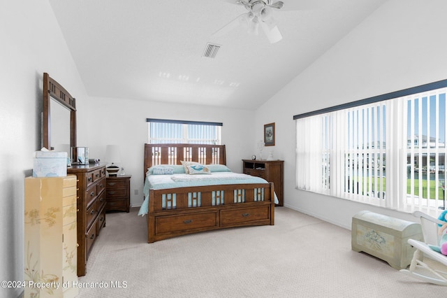 bedroom featuring light carpet, ceiling fan, and vaulted ceiling