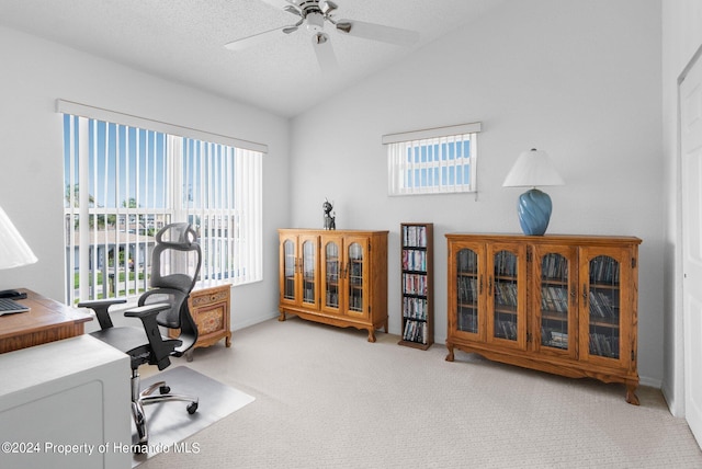 office area featuring lofted ceiling, light colored carpet, ceiling fan, and plenty of natural light