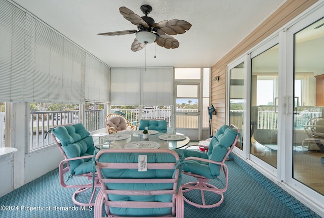 sunroom featuring plenty of natural light and ceiling fan