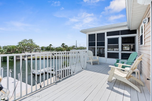 deck featuring a water view and a sunroom