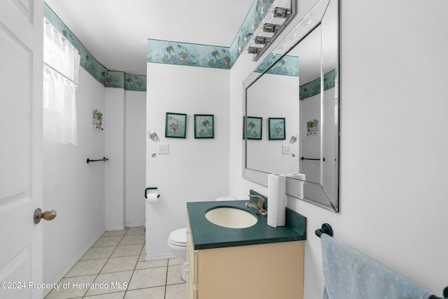 bathroom featuring vanity, tile patterned floors, and toilet