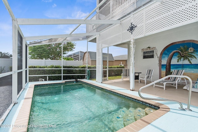 view of pool with a patio and a lanai