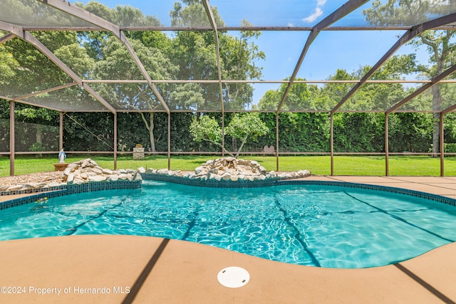 view of pool featuring a patio area, a yard, and a lanai