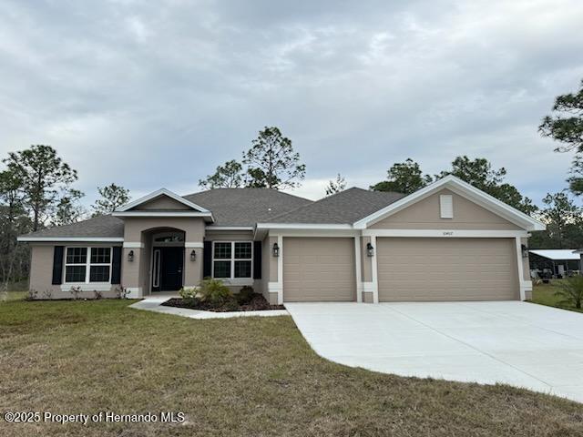 view of front of house with a garage and a front yard