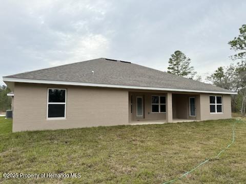 rear view of house with a lawn