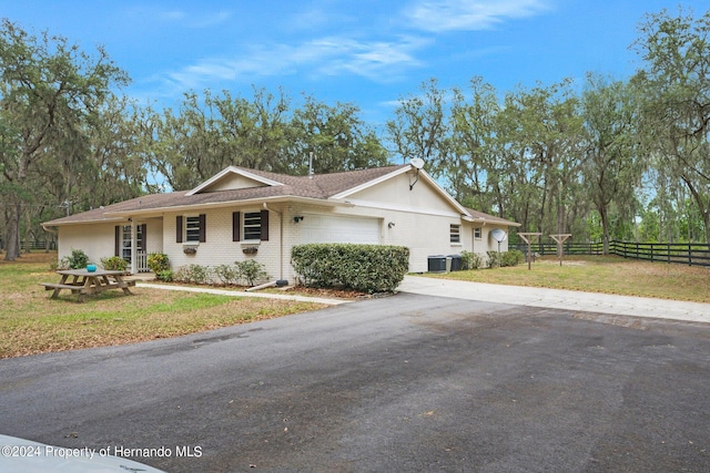 ranch-style home with a garage and a front yard