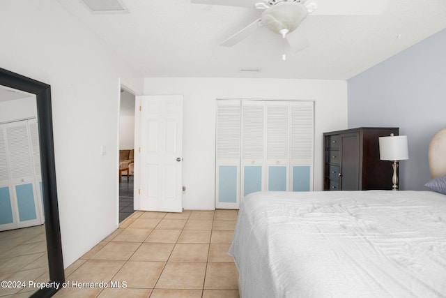 bedroom featuring light tile patterned floors and ceiling fan