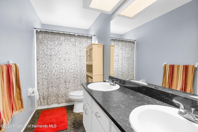 bathroom with walk in shower, vanity, and toilet