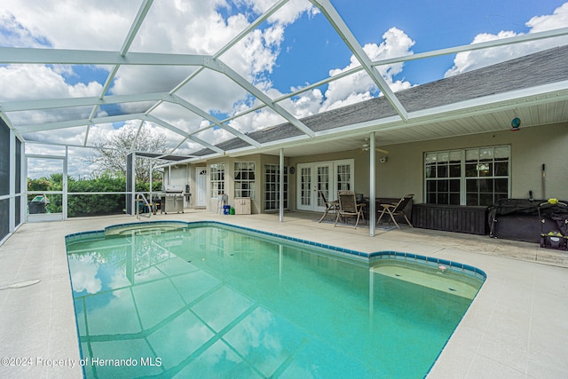 view of swimming pool with a patio area, french doors, a lanai, and ceiling fan