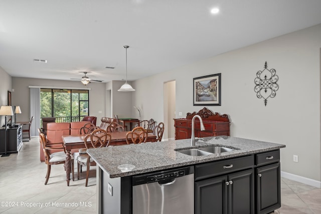 kitchen with ceiling fan, sink, pendant lighting, dishwasher, and an island with sink