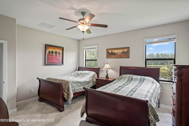 tiled bedroom with ceiling fan