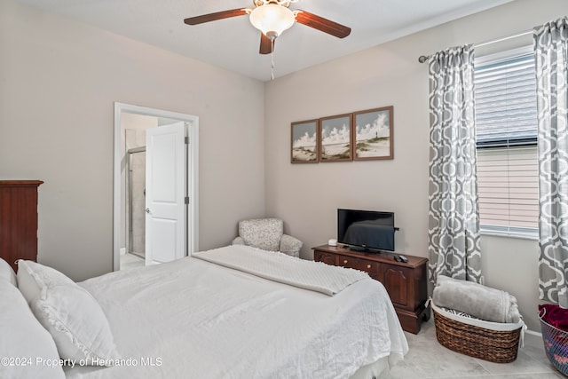 tiled bedroom with ensuite bath and ceiling fan