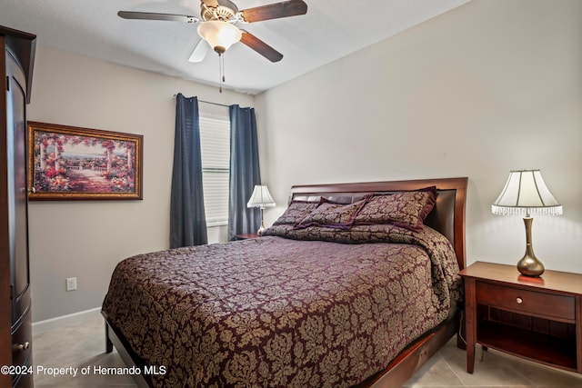 tiled bedroom with ceiling fan