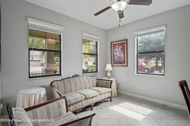 tiled living room featuring ceiling fan and a wealth of natural light