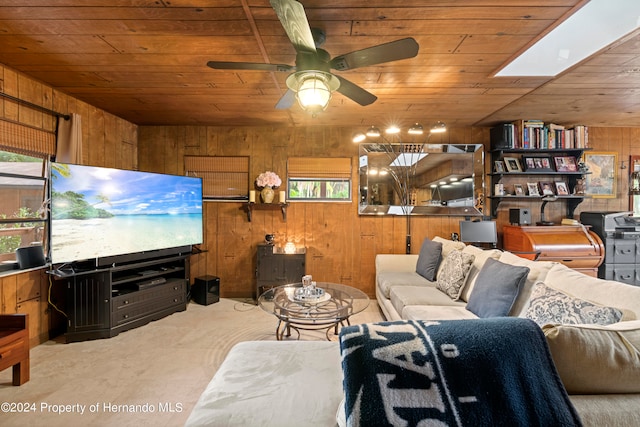 living room with wood ceiling, wooden walls, ceiling fan, and plenty of natural light