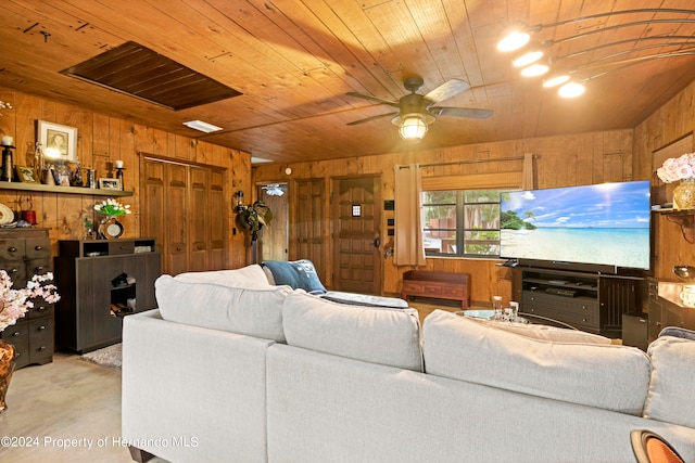 living room with wood walls, ceiling fan, and wood ceiling