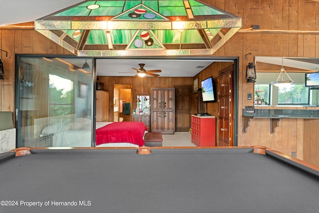 living room featuring billiards, wood walls, and vaulted ceiling