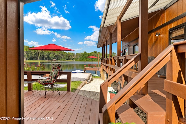 wooden deck featuring a water view