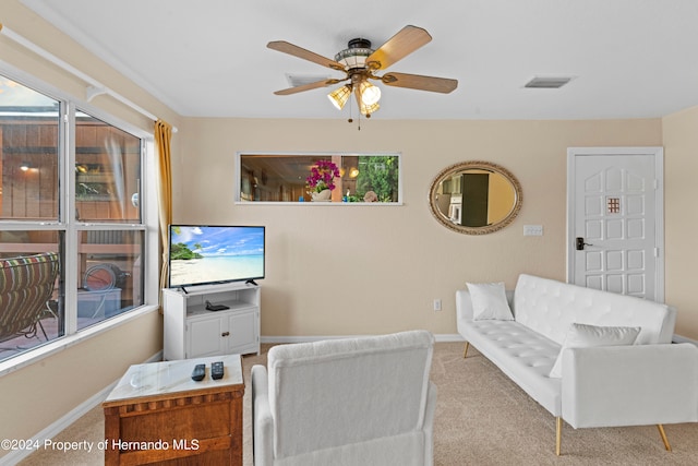 carpeted living room featuring ceiling fan