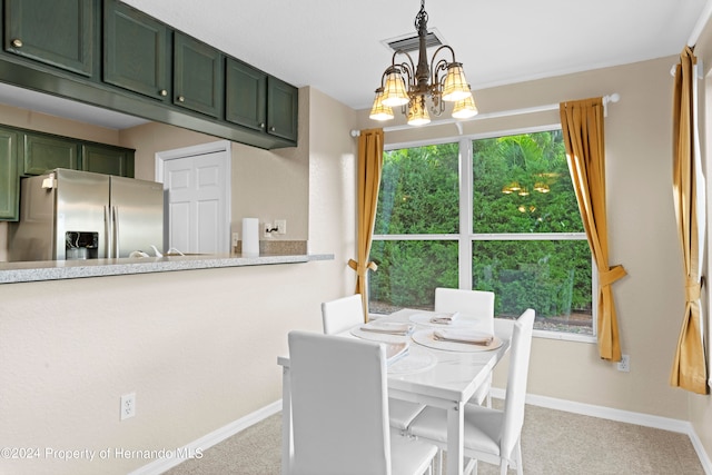 dining area featuring light carpet and a notable chandelier