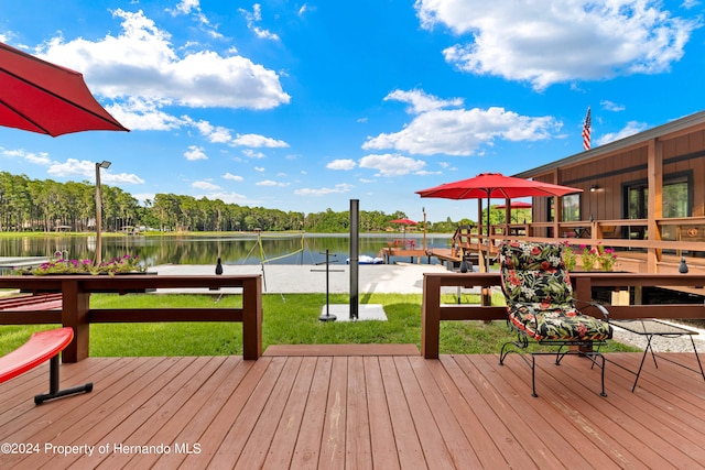 deck featuring a lawn and a water view