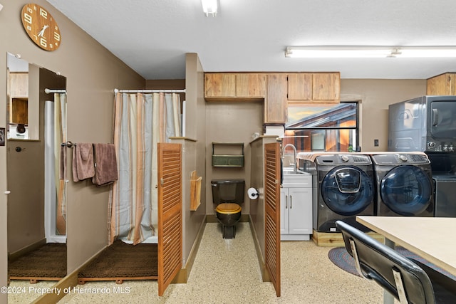 laundry area featuring washing machine and dryer and sink