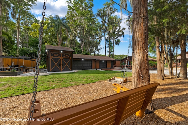 view of yard featuring a garage and a storage shed