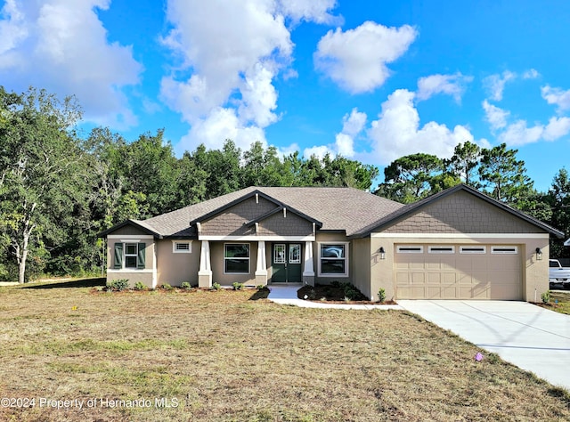 view of front of property featuring a garage and a front lawn