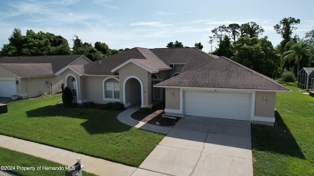 view of front facade featuring a garage and a front lawn