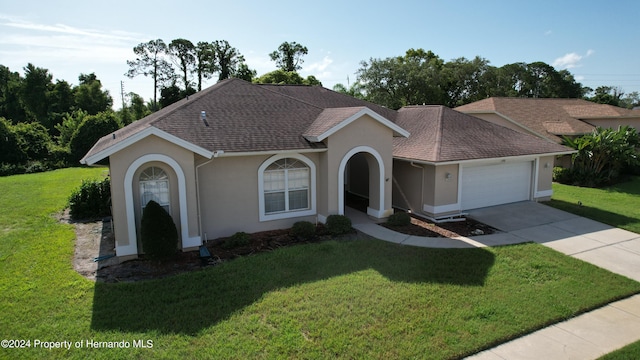 single story home with a front lawn and a garage