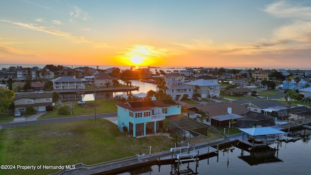 aerial view at dusk with a water view