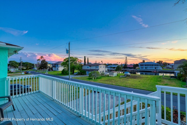 deck at dusk with a lawn