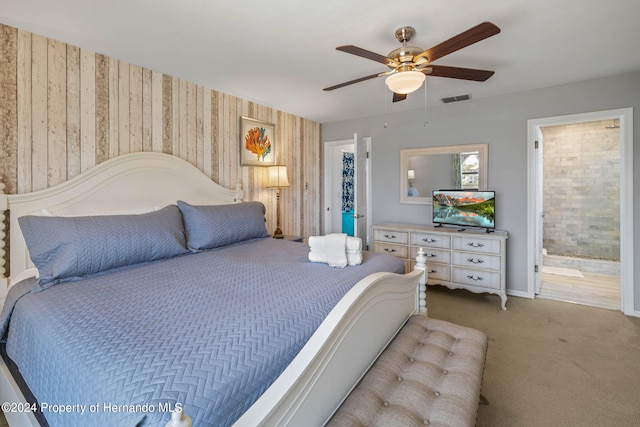 bedroom with carpet floors, ceiling fan, and ensuite bathroom