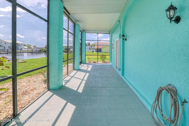 unfurnished sunroom with a water view