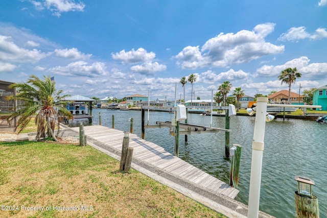 dock area featuring a yard and a water view