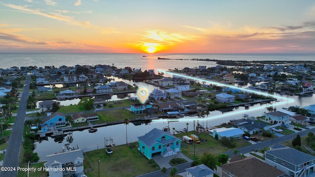 aerial view at dusk with a water view