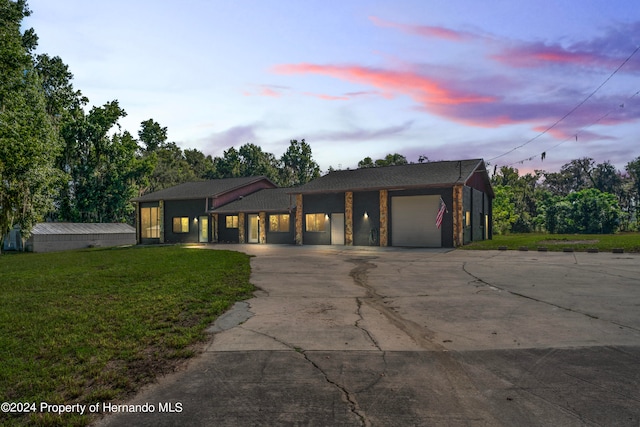 view of front of property featuring a garage and a yard