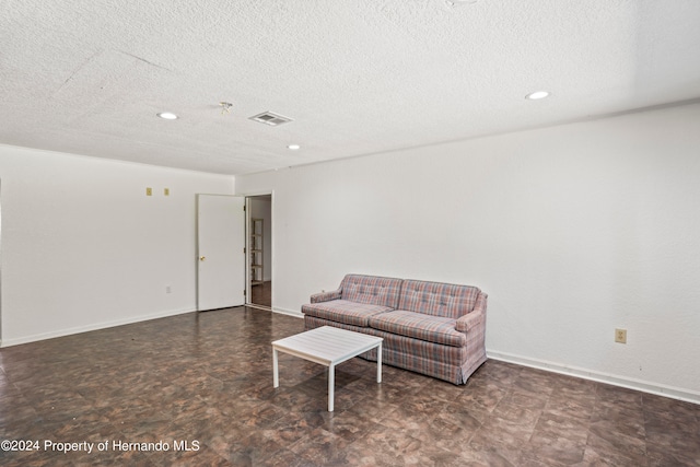 living room with a textured ceiling