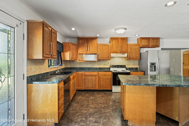 kitchen with a kitchen island, stainless steel fridge with ice dispenser, white electric stove, sink, and dishwasher