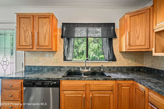 kitchen featuring stainless steel dishwasher, crown molding, sink, and decorative backsplash