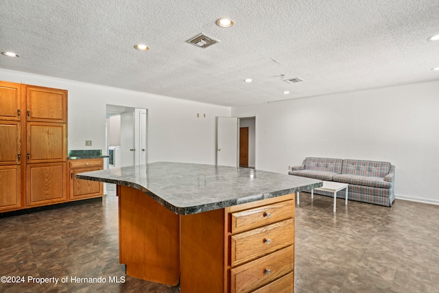 kitchen featuring a textured ceiling and a center island